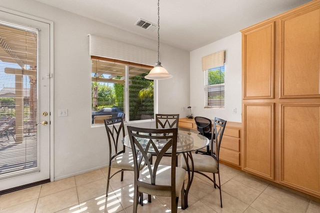 tiled dining space featuring plenty of natural light