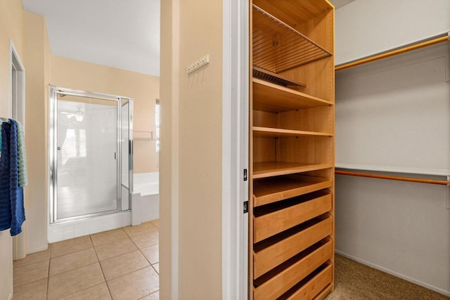 spacious closet featuring light tile patterned floors