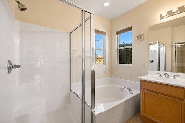 bathroom featuring vanity and independent shower and bath