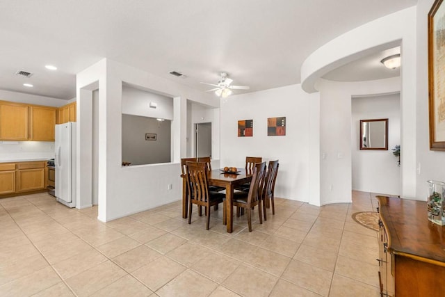 tiled dining space featuring ceiling fan