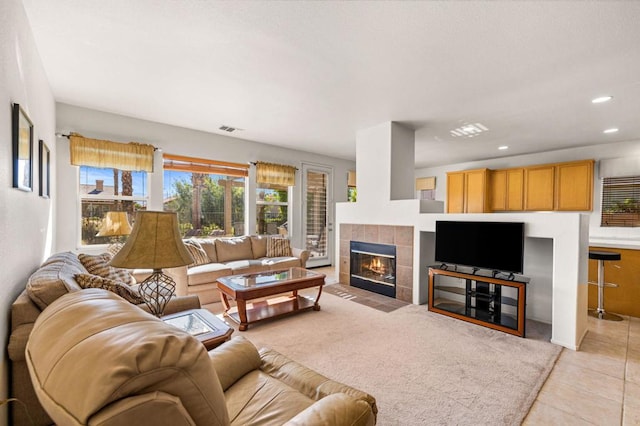 living room featuring light tile patterned floors and a fireplace