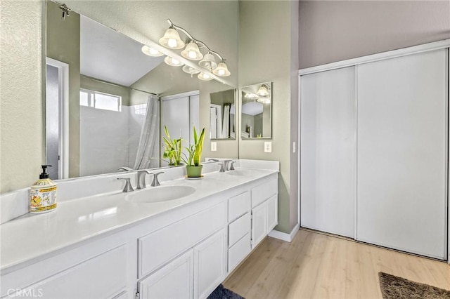 bathroom with vanity and hardwood / wood-style floors