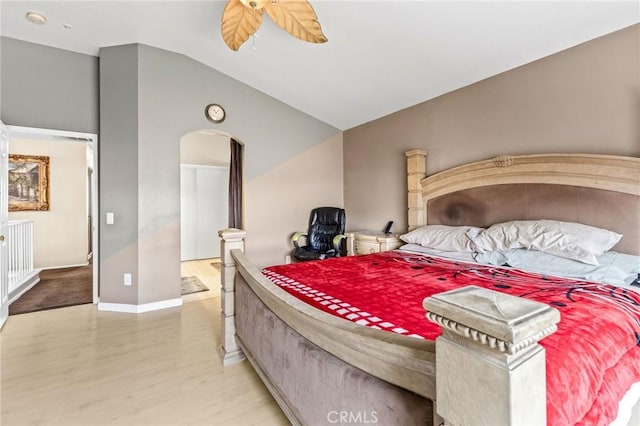 bedroom featuring lofted ceiling, ceiling fan, and light wood-type flooring