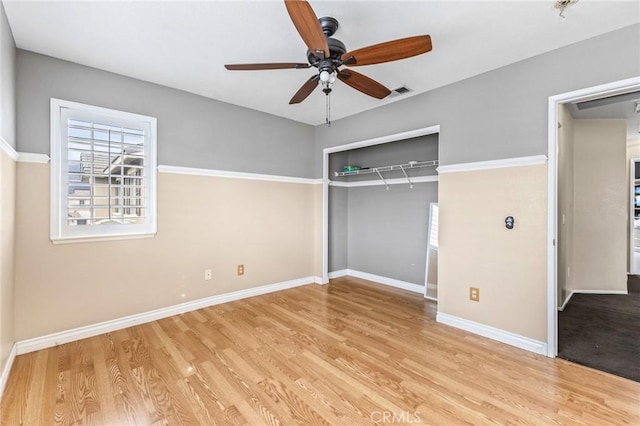 unfurnished bedroom with light hardwood / wood-style floors, a closet, and ceiling fan