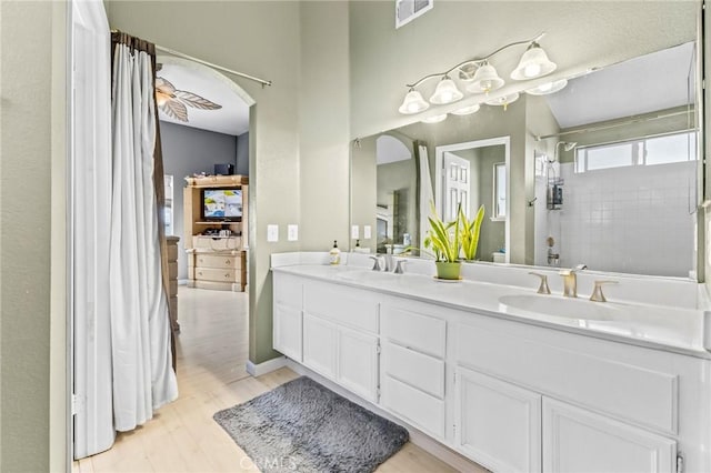 bathroom with vanity, a shower with curtain, wood-type flooring, and ceiling fan