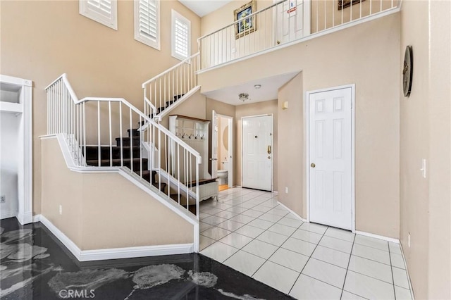 tiled foyer featuring a high ceiling