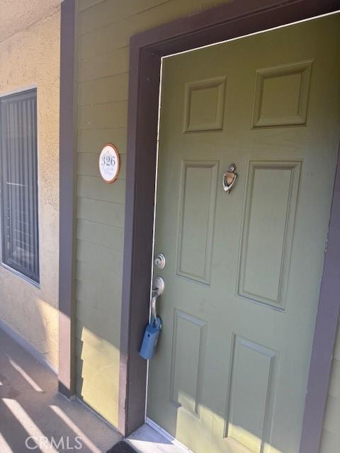 doorway to property with stucco siding