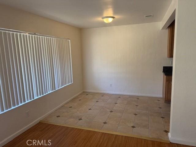 spare room with light hardwood / wood-style floors