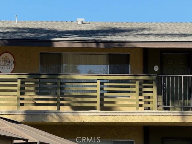 exterior space with roof with shingles