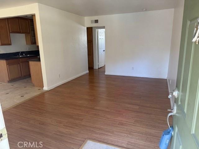 interior space featuring dark hardwood / wood-style flooring and sink