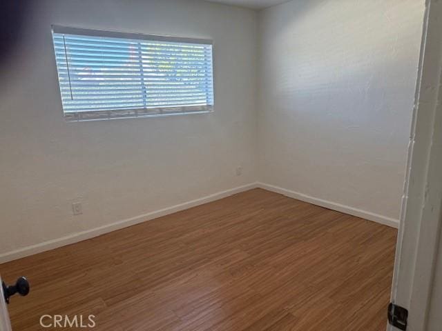 empty room with hardwood / wood-style floors