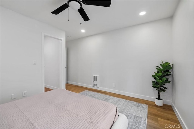 bedroom featuring hardwood / wood-style floors and ceiling fan