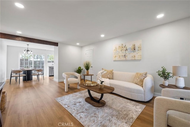 living room featuring wood-type flooring and a chandelier