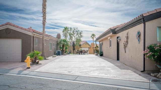 exterior space featuring central AC and a garage