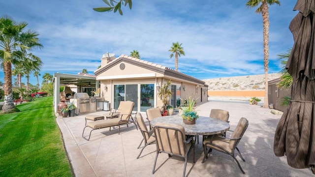 view of patio / terrace featuring an outdoor kitchen and a mountain view