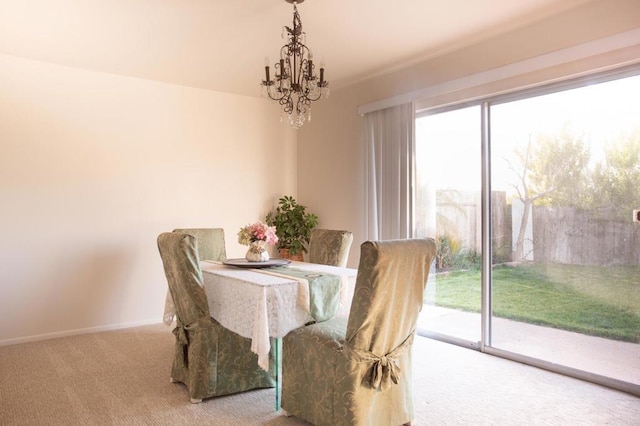 dining room with a chandelier and carpet