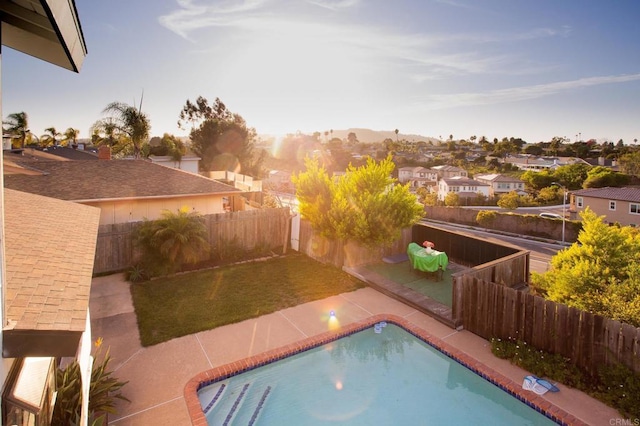 view of swimming pool with a patio and a lawn