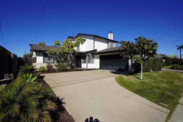 view of front of home featuring a garage and a front yard