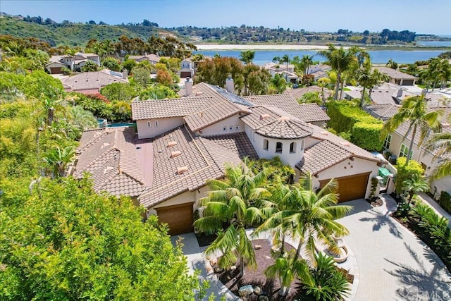 birds eye view of property with a water view