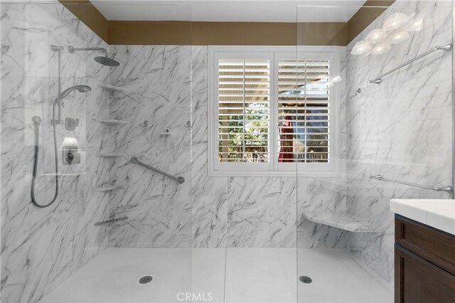 bathroom with vanity and a tile shower