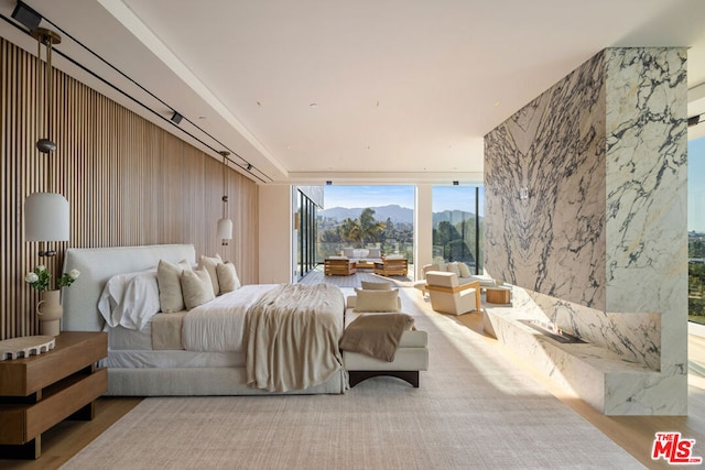 bedroom featuring expansive windows and a mountain view