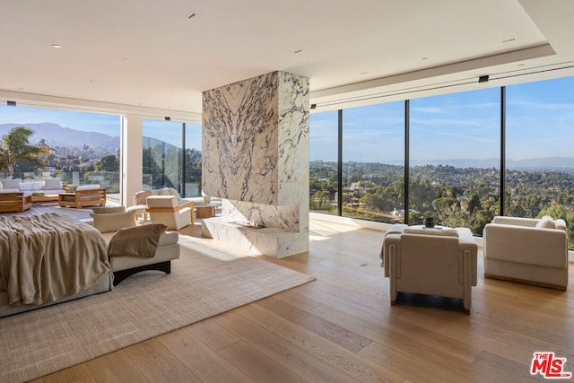 bedroom with a mountain view and light hardwood / wood-style flooring