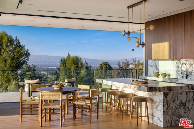 exterior space featuring a mountain view and an outdoor wet bar