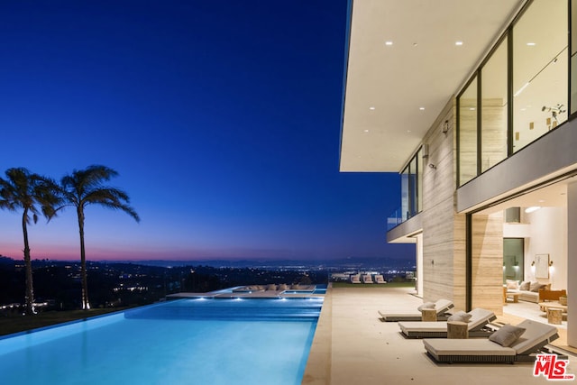 view of pool at dusk