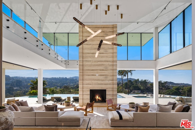 living room featuring a large fireplace and a mountain view