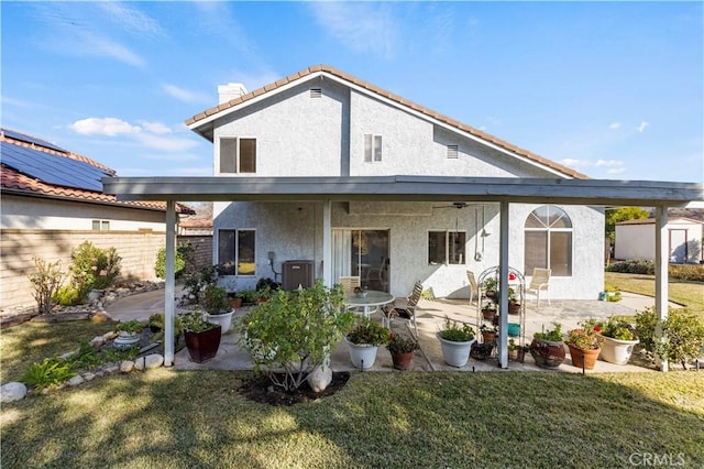 rear view of house featuring a yard and a patio