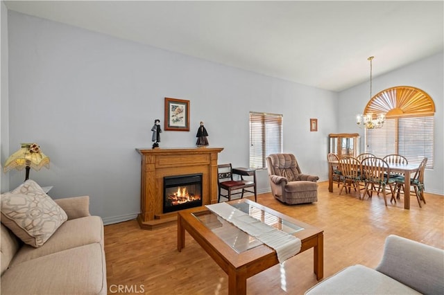 living room with an inviting chandelier and light hardwood / wood-style floors