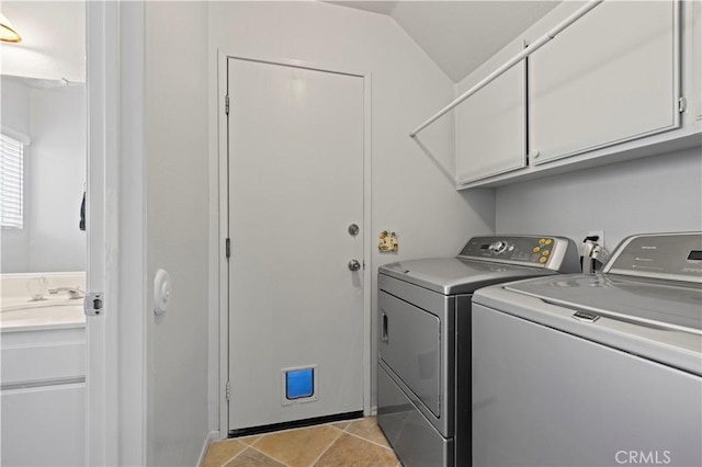 washroom featuring cabinets, sink, and washing machine and dryer