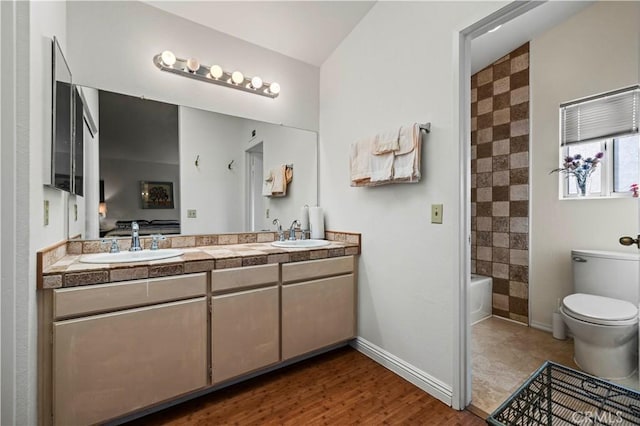 full bathroom with vanity, toilet, shower / bath combination, and wood-type flooring