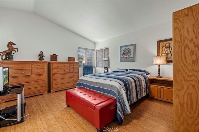 bedroom featuring vaulted ceiling and light hardwood / wood-style flooring