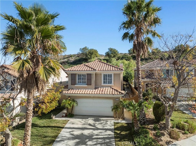 mediterranean / spanish-style house with a garage