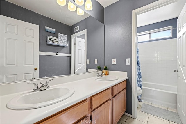 full bathroom featuring shower / bath combo with shower curtain, tile patterned floors, toilet, and vanity