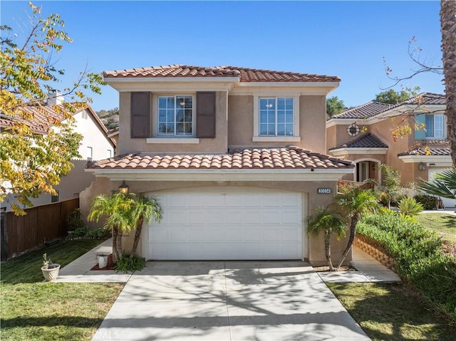 mediterranean / spanish house with a garage