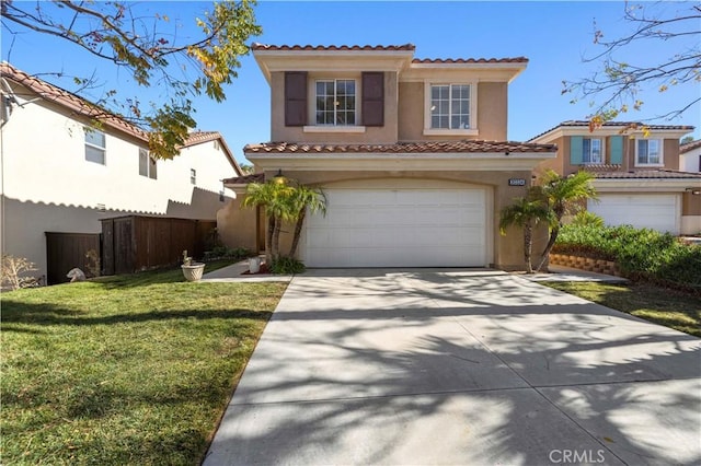 mediterranean / spanish-style home with a garage and a front lawn