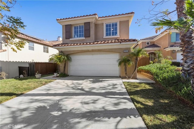 mediterranean / spanish home with a garage and a front lawn