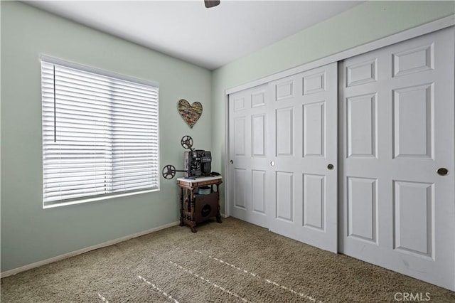 unfurnished bedroom featuring carpet, ceiling fan, and a closet