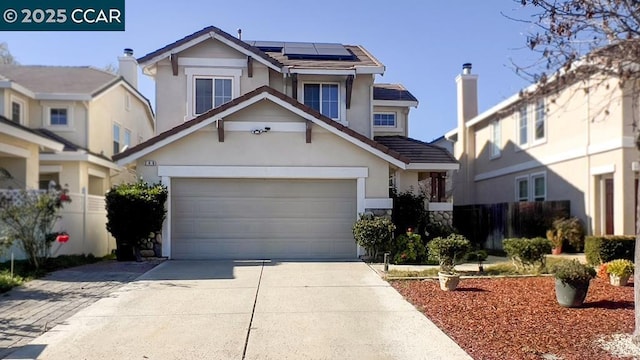 view of front of house with a garage and solar panels