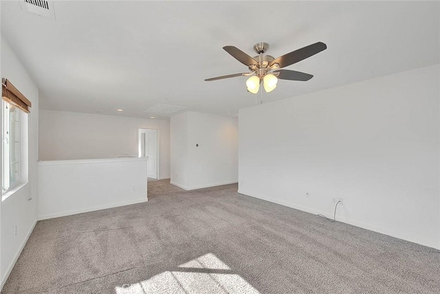 carpeted spare room with ceiling fan