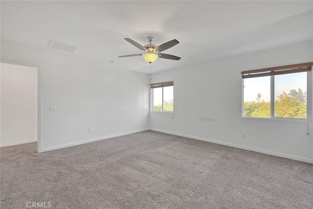 carpeted spare room with ceiling fan