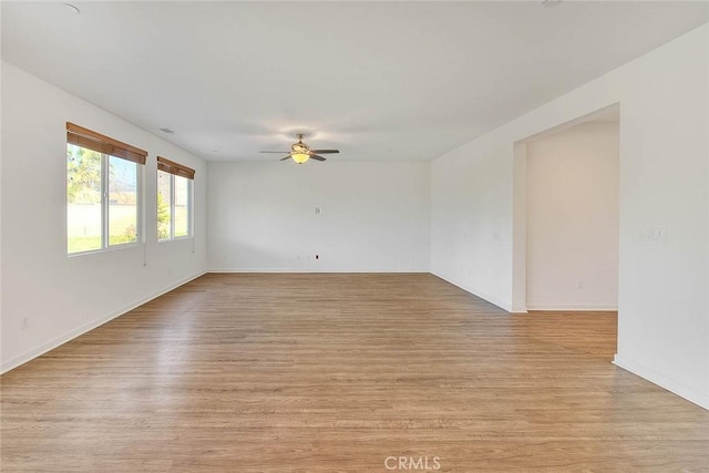 spare room featuring ceiling fan and light wood-type flooring