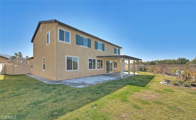 back of house with a patio, a lawn, and a pergola