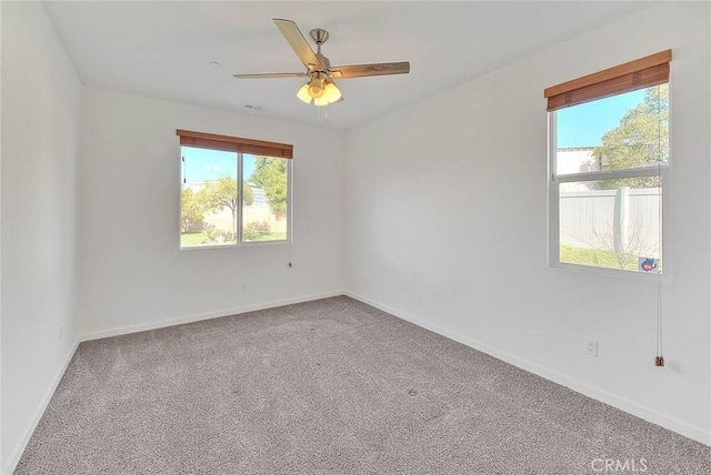 carpeted empty room featuring ceiling fan