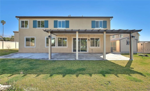 rear view of property featuring a patio and a yard