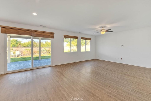 empty room with ceiling fan and light wood-type flooring