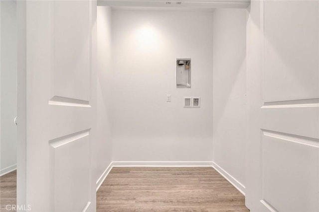 washroom featuring hookup for an electric dryer, light hardwood / wood-style floors, and hookup for a washing machine