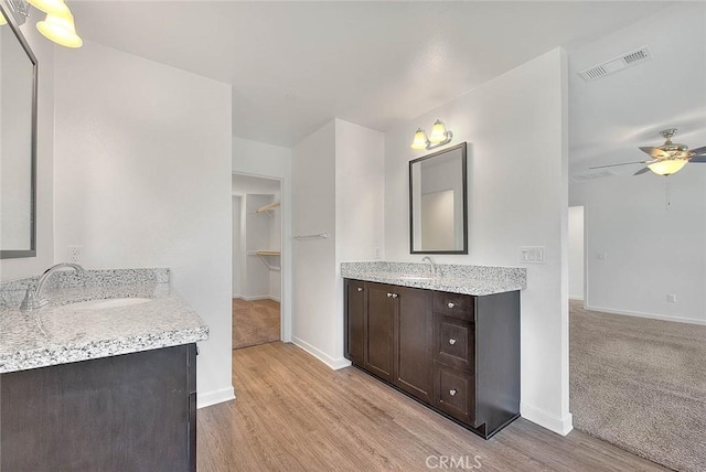 bathroom with vanity, hardwood / wood-style flooring, and ceiling fan